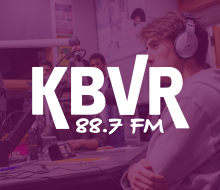 students in a radio both with the logo KBVR 88.7 fm written across the middle