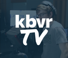 a student in a recording booth with kbvrTV written across the middle